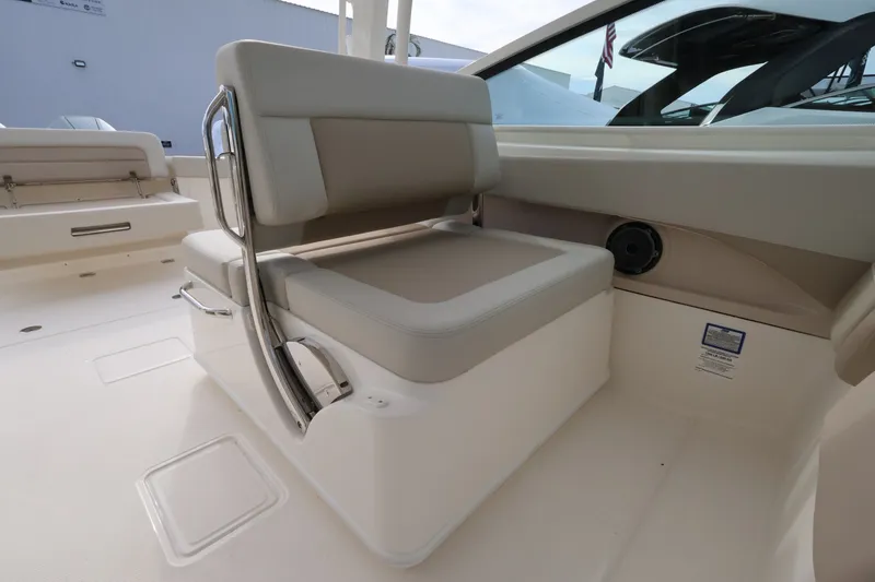 Slide: The Image of The 2027 Boston Whaler 280 Vantage features a sleek, cushioned bench seat in a modern boat. - 15