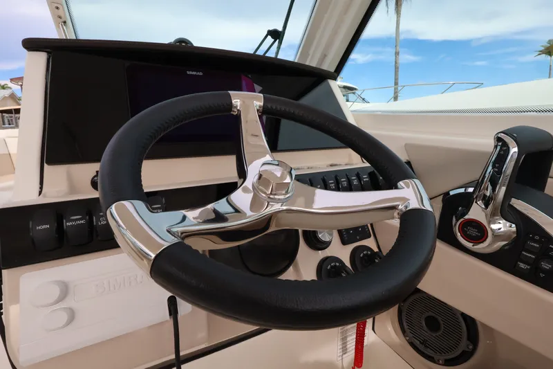 Slide: The Image of The image shows the helm of a 2027 Boston Whaler 280 Vantage with modern controls. - 23