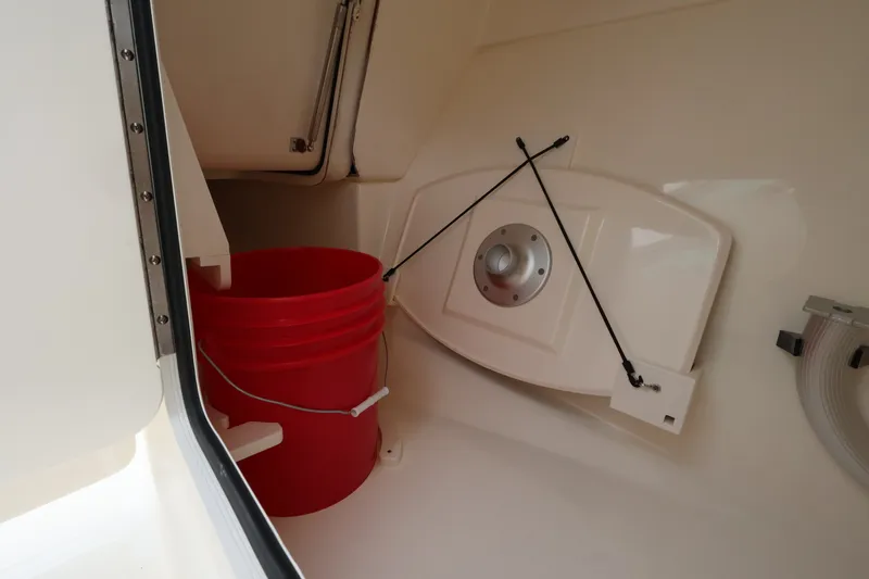 Slide: The Image of Interior of a Boston Whaler 280 Vantage with a red bucket and storage area. - 30