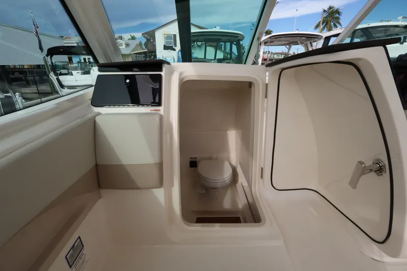 Slide: The Image of Interior view of a boat cabin with a toilet and storage space. - 25