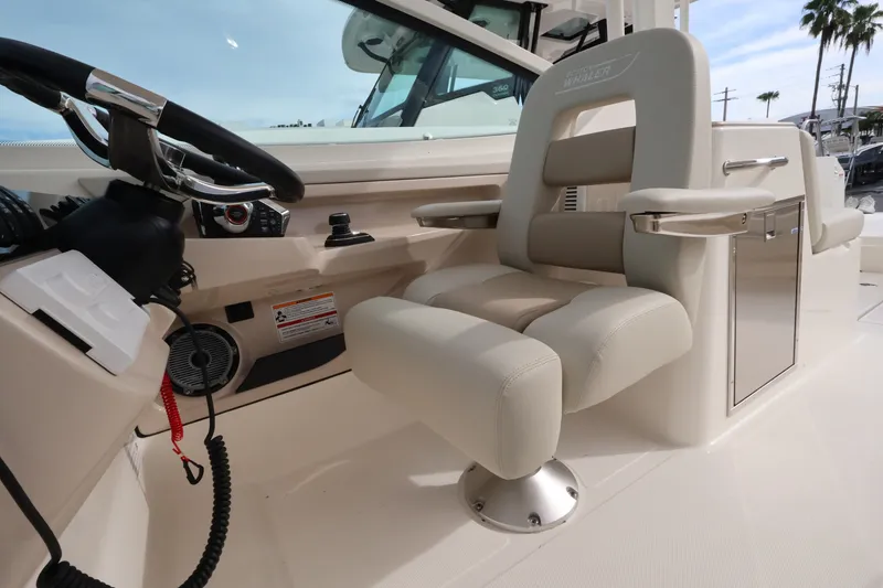Slide: The Image of The helm of a 2027 Boston Whaler 280 Vantage with a beige seat and steering wheel. - 19