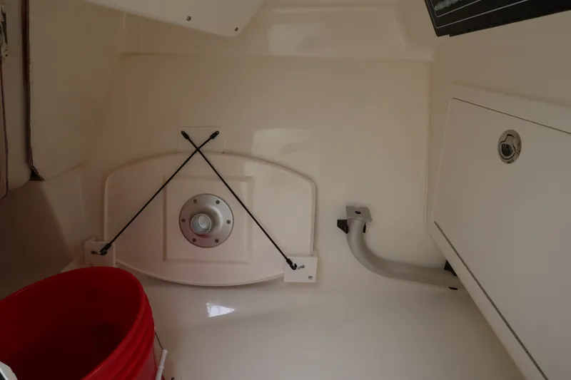Slide: The Image of Interior of a Boston Whaler 280 Vantage with storage space and a red bucket. - 31