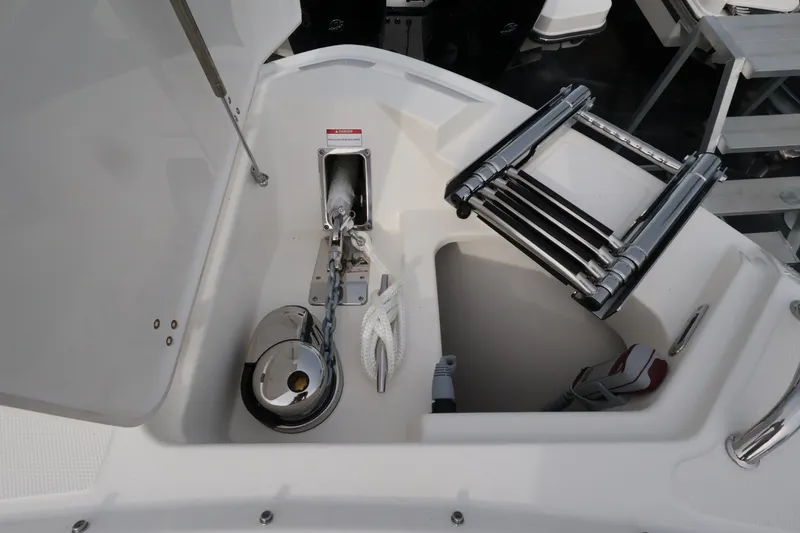 Slide: The Image of Anchor compartment with anchor, rope, and ladder on a boat. - 35