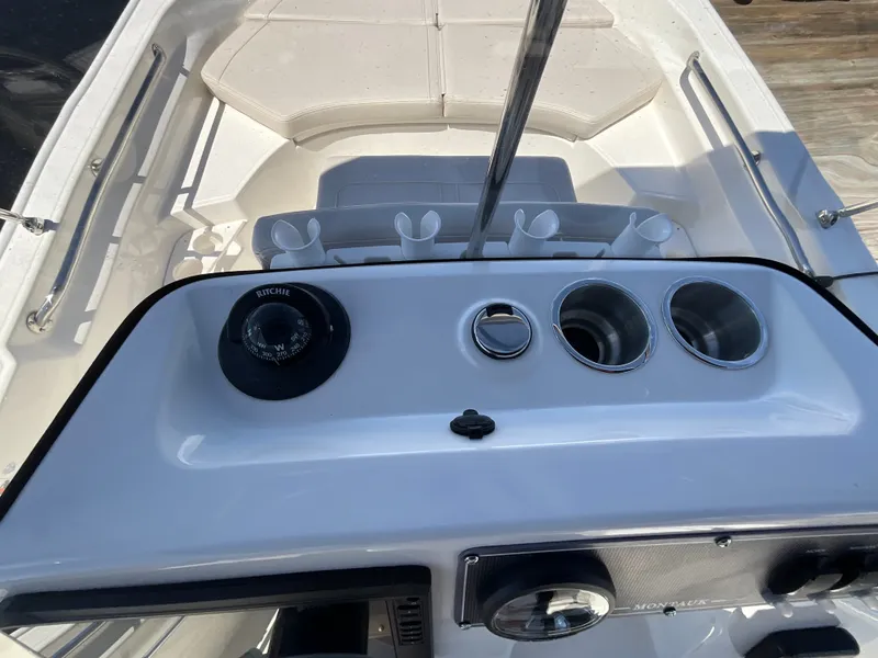 Slide: The Image of The image shows the cockpit of a 2027 Boston Whaler 170 Montauk with a helm console and seating area. - 8