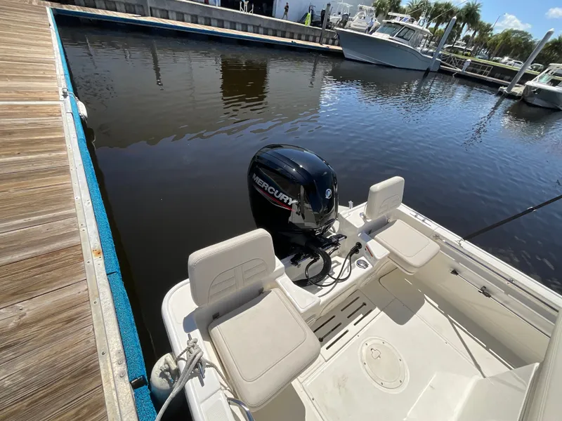 Slide: The Image of The image shows a 2027 Boston Whaler 170 Montauk boat docked at a pier. - 16