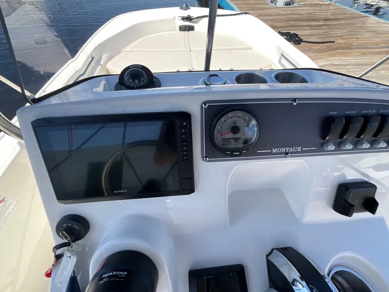 Slide: The Image of The cockpit of a 2027 Boston Whaler 170 Montauk with modern instruments and controls. - 9