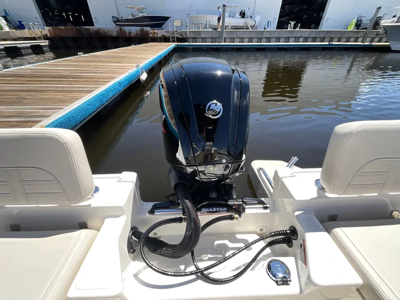 Slide: The Image of The image shows the stern of a Boston Whaler 170 Montauk with an outboard motor at the dock. - 20