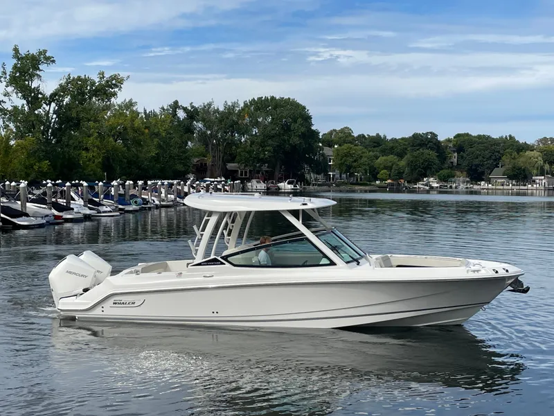 Slide: The Image of 2027 Boston Whaler 280 Vantage on calm water, featuring sleek design and spacious cockpit. - 9