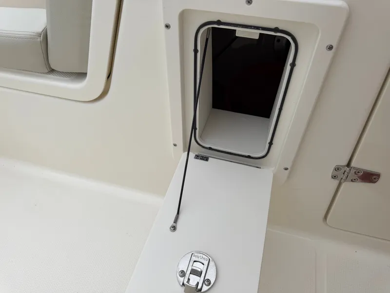 Slide: The Image of An open hatch on a boat with a small storage compartment. - 48