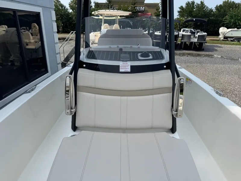 Slide: The Image of The image shows the cockpit of a 2027 Boston Whaler 250 Dauntless with beige seating. - 22