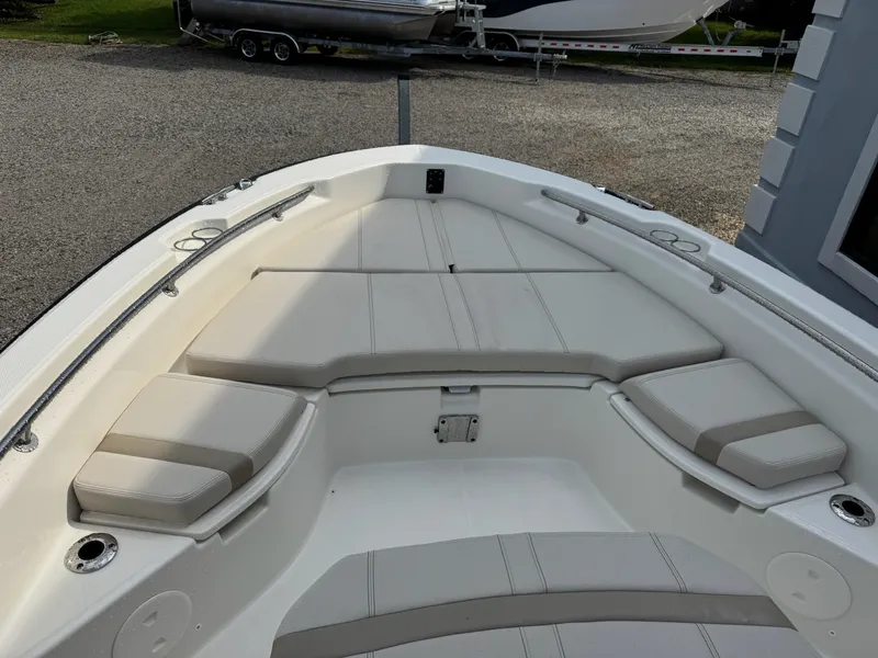 Slide: The Image of The image shows the bow of a Boston Whaler 250 Dauntless with cushioned seating areas. - 19