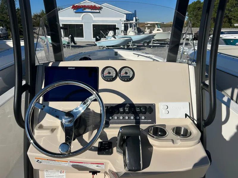 Slide: The Image of The image shows the helm of a Boston Whaler 250 Dauntless with steering wheel and instruments. - 16