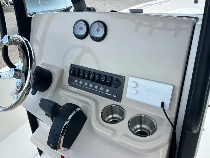 Slide: The Image of The image shows the helm of a Boston Whaler 250 Dauntless boat with instruments and controls. - 16