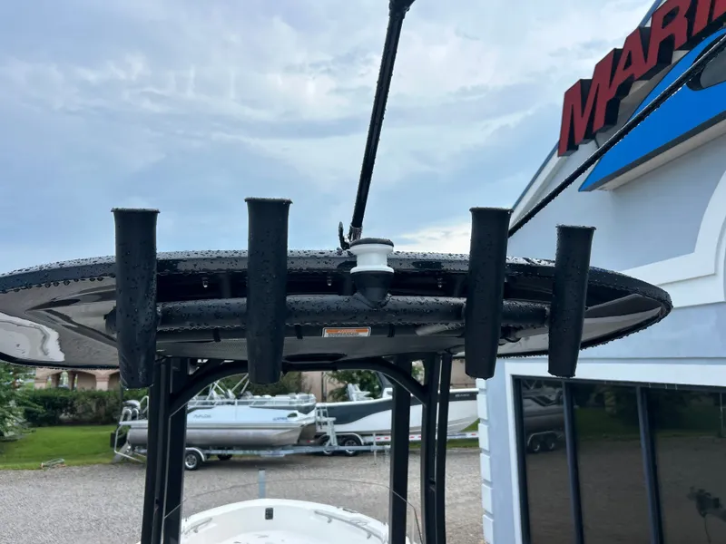 Slide: The Image of A boat with a black T-top and multiple fishing rod holders, with another boat in the background. - 13