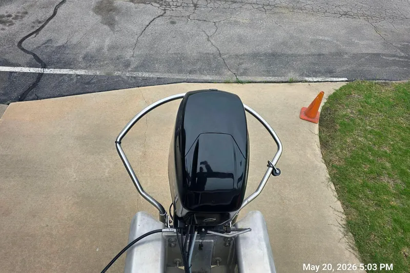 Slide: The Image of 2021 Sun Tracker Bass Buggy 16 XL Select outboard motor on pavement near grass and cone. - 5