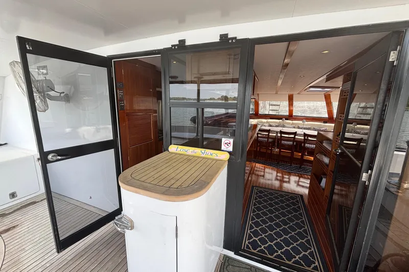 Slide: The Image of Interior view of 2006 Lidgard Custom Catamaran, featuring elegant wood finishes and spacious seating. - 11