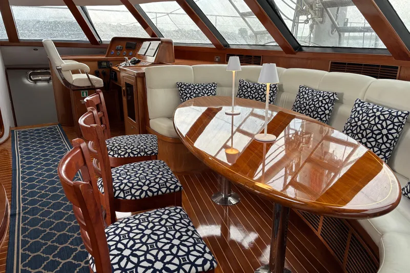 Slide: The Image of Luxurious 2006 Lidgard Custom Catamaran interior with elegant seating and polished wood table. - 13