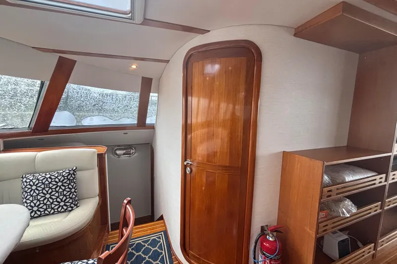 Slide: The Image of Interior of 2006 Lidgard Custom Catamaran with wooden door, seating, and shelving. - 14
