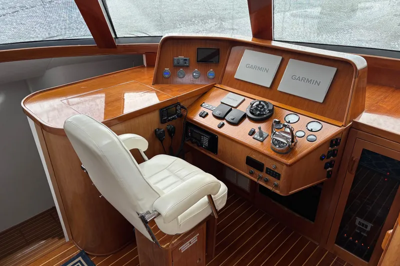 Slide: The Image of Luxurious 2006 Lidgard Custom Catamaran helm with Garmin navigation systems and elegant wood finish. - 16