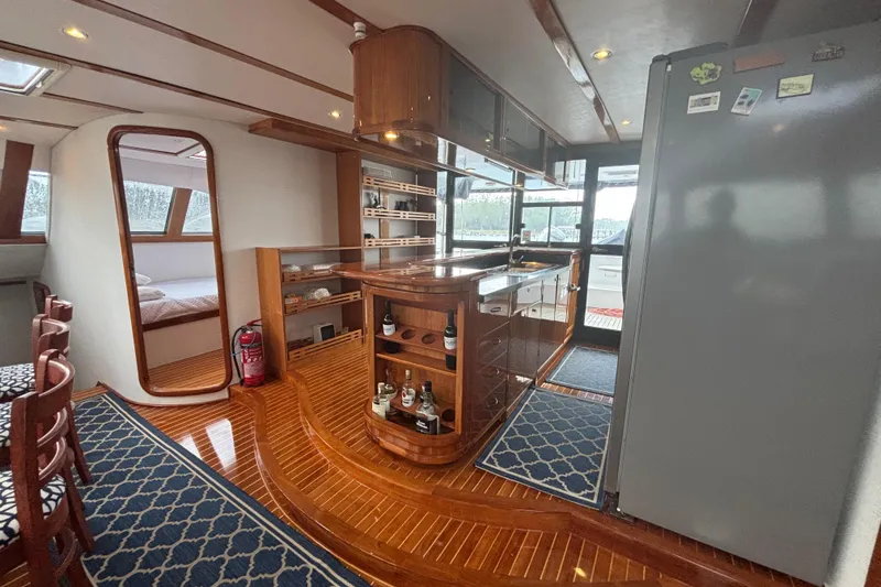 Slide: The Image of Luxurious 2006 Lidgard Custom Catamaran interior with wood finishes and modern amenities. - 20