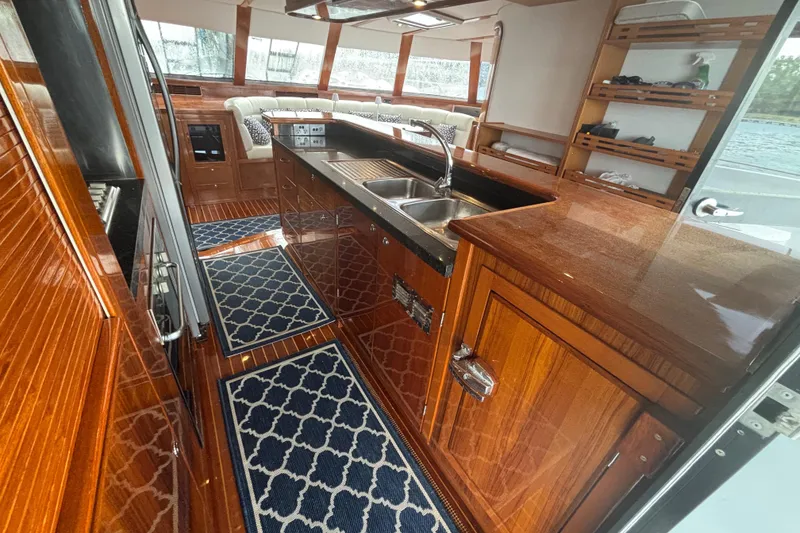 Slide: The Image of Luxurious 2006 Lidgard Custom Catamaran interior with polished wood and modern kitchen amenities. - 21