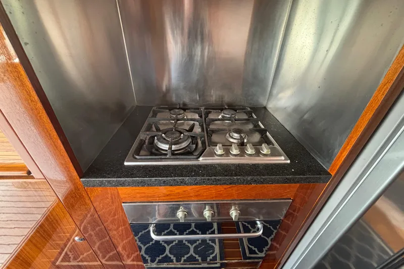 Slide: The Image of Stainless steel stove in 2006 Lidgard Custom Catamaran kitchen with wooden cabinetry. - 22