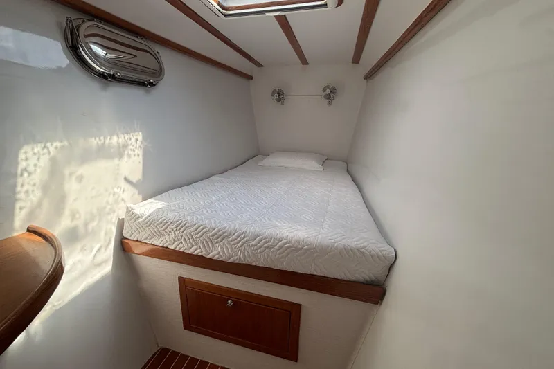 Slide: The Image of Cozy cabin interior of 2006 Lidgard Custom Catamaran with bed and porthole. - 28