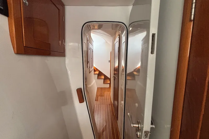 Slide: The Image of Interior hallway of 2006 Lidgard Custom Catamaran with wooden cabinetry and flooring. - 29