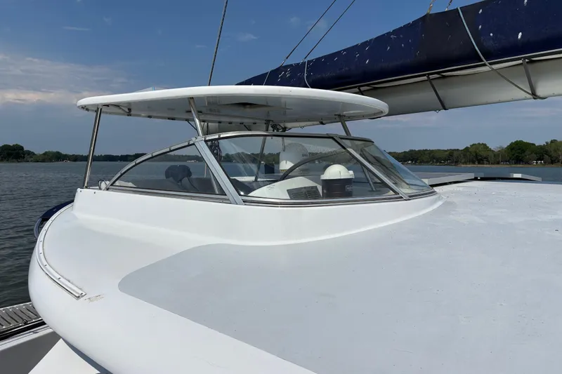 Slide: The Image of 2006 Lidgard Custom Catamaran on calm water, featuring sleek design and spacious deck. - 3