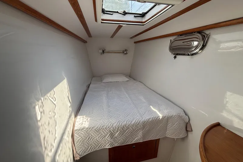 Slide: The Image of Cozy cabin interior of 2006 Lidgard Custom Catamaran with bed and porthole. - 30