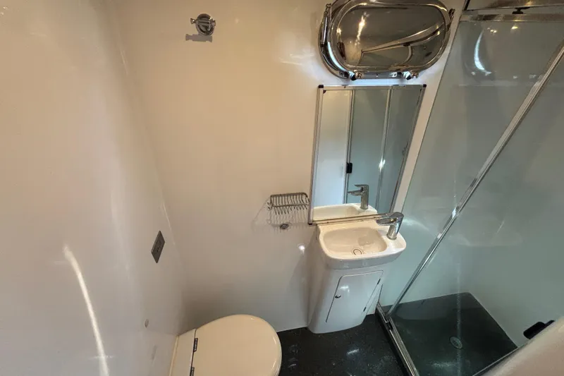 Slide: The Image of Bathroom interior of 2006 Lidgard Custom Catamaran with sink, mirror, and shower. - 32