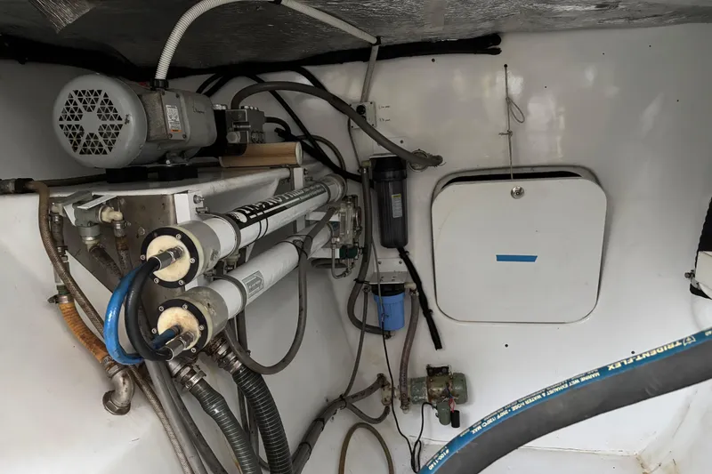 Slide: The Image of Engine room of a 2006 Lidgard Custom Catamaran with visible machinery and piping. - 33