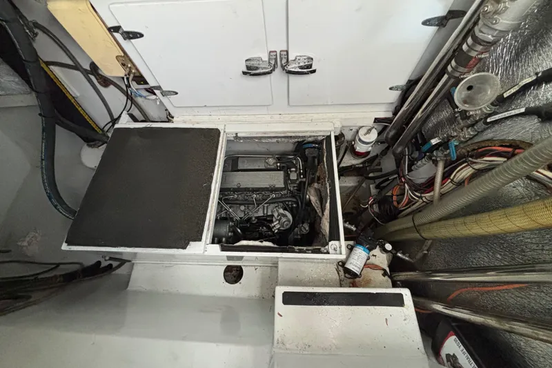 Slide: The Image of Engine compartment of a 2006 Lidgard Custom Catamaran, showcasing mechanical components and wiring. - 35