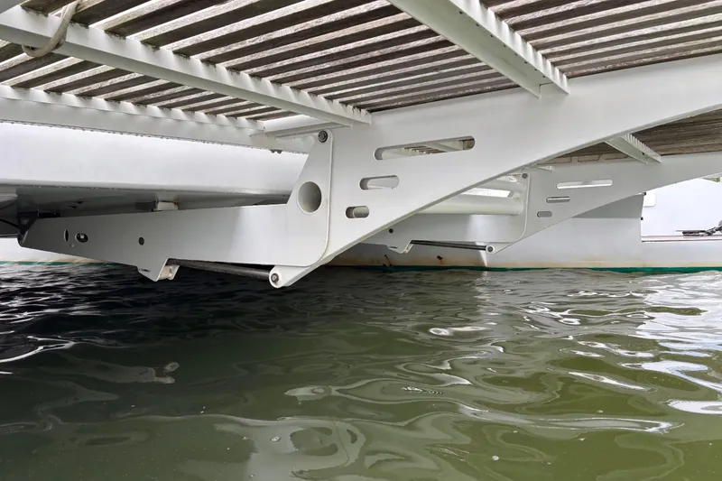 Slide: The Image of Underneath view of a 2006 Lidgard Custom Catamaran, showcasing structural details above water. - 38