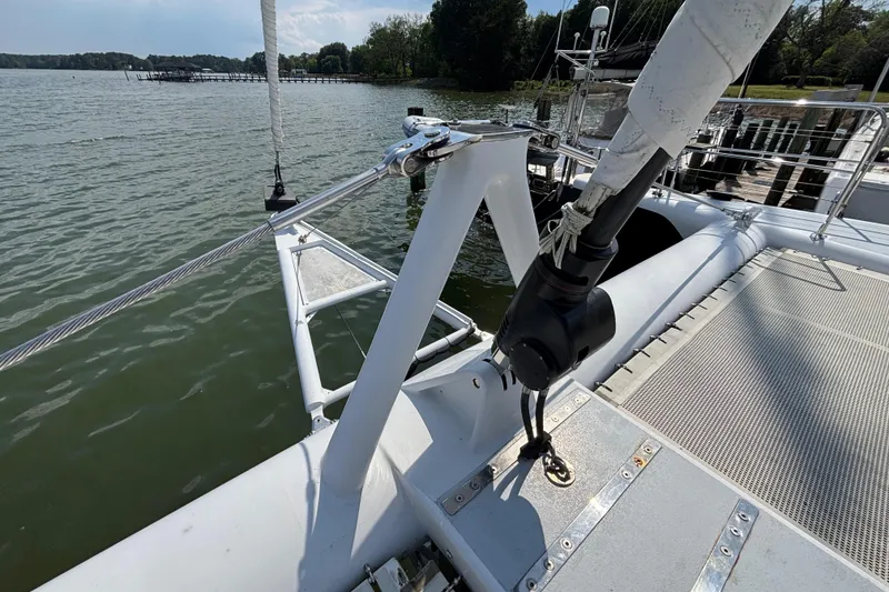 Slide: The Image of Lidgard Custom Catamaran 2006, docked by a serene lake with lush greenery. - 4