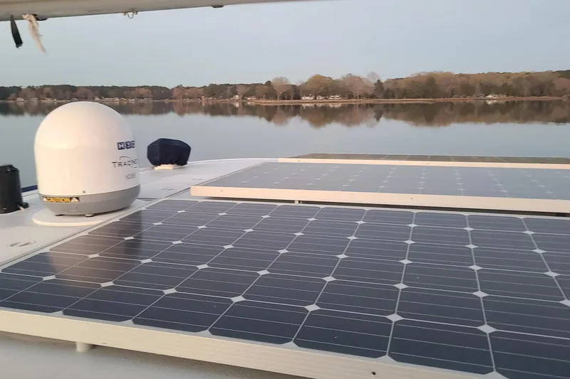 Slide: The Image of Solar panels on 2006 Lidgard Custom Catamaran, reflecting serene lake view. - 40