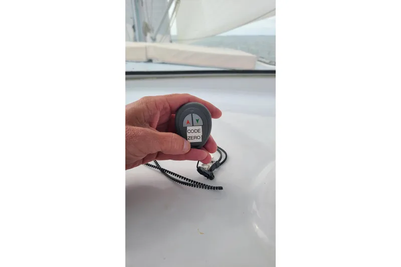 Slide: The Image of Hand holding a remote labeled "Code Zero" on a 2006 Lidgard Custom Catamaran. - 41