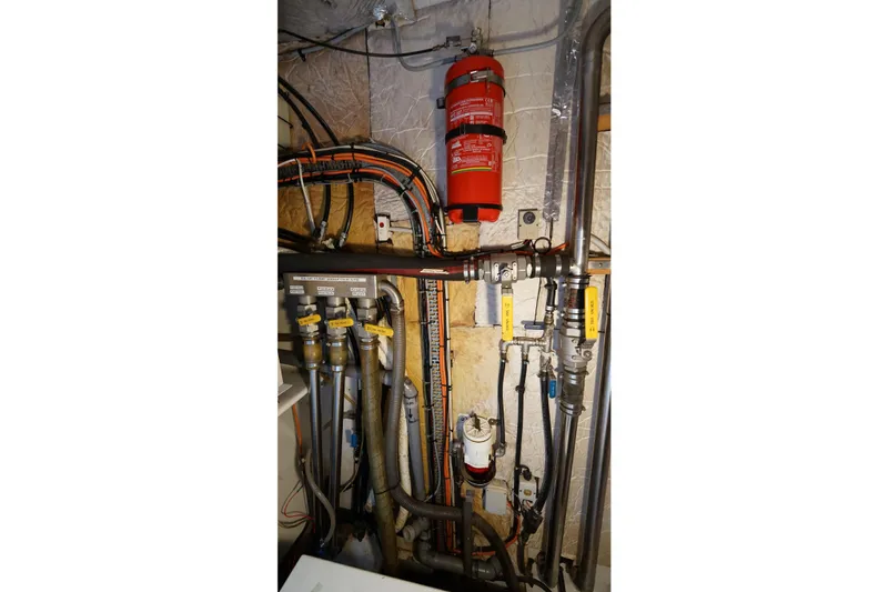 Slide: The Image of Engine room of a 2006 Lidgard Custom Catamaran with fire extinguisher and plumbing system. - 42