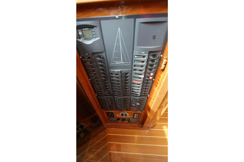 Slide: The Image of Electrical control panel inside a 2006 Lidgard Custom Catamaran, featuring multiple switches and indicators. - 44