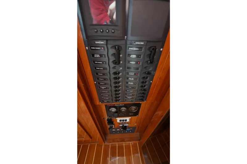 Slide: The Image of Electrical control panel on a 2006 Lidgard Custom Catamaran, featuring switches and gauges. - 45