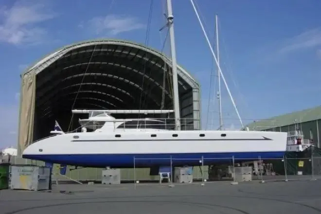 Slide: The Image of Lidgard Custom Catamaran 2006 in front of a large boat hangar. - 49