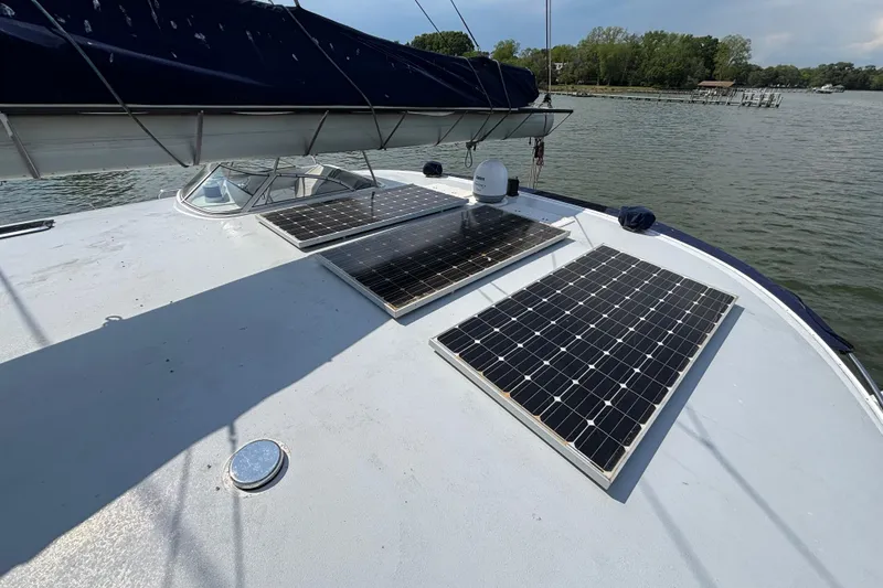 Slide: The Image of Solar panels on 2006 Lidgard Custom Catamaran deck, docked by a serene lake. - 6