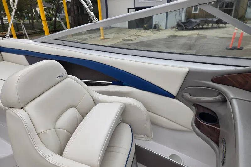 Slide: The Image of Interior of a 2001 Four Winns 230 Horizon boat, featuring white and blue seating. - 12