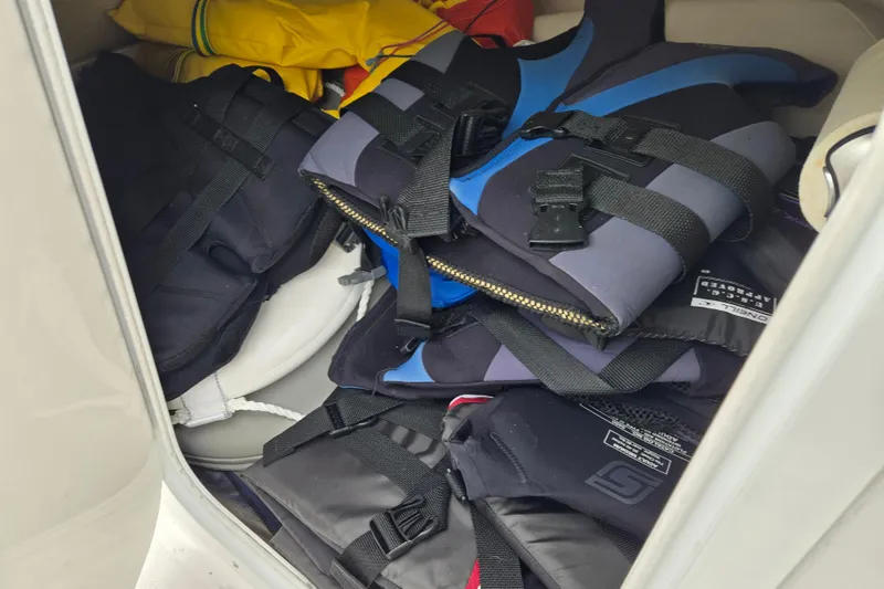 Slide: The Image of Life jackets stored in a 2001 Four Winns 230 Horizon boat compartment. - 16