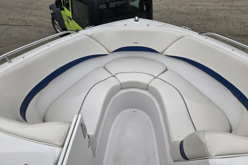 Slide: The Image of 2001 Four Winns 230 Horizon boat with white and blue cushioned seating. - 17