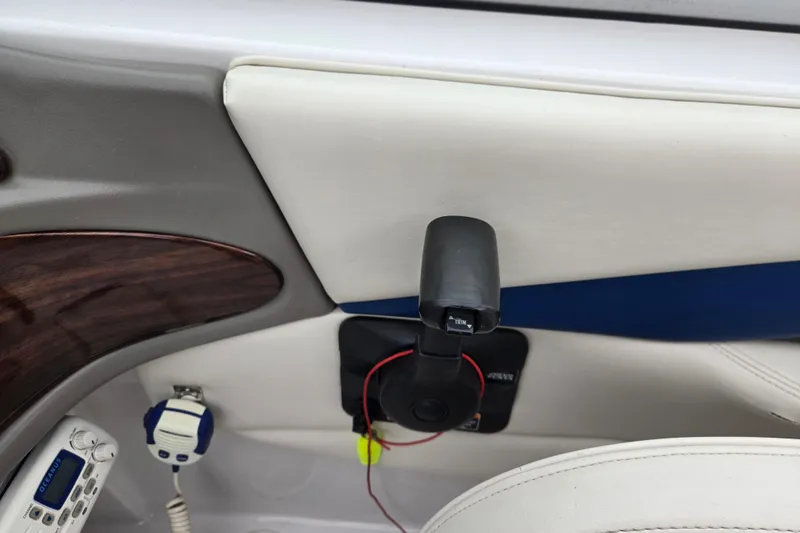 Slide: The Image of Interior of a 2001 Four Winns 230 Horizon boat, featuring control panel and trim lever. - 19