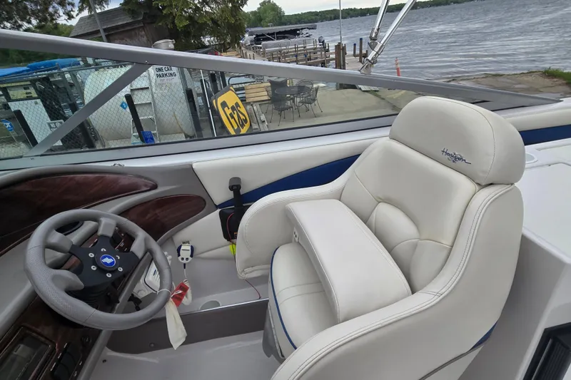 Slide: The Image of Interior of 2001 Four Winns 230 Horizon boat with steering wheel and plush seating. - 30