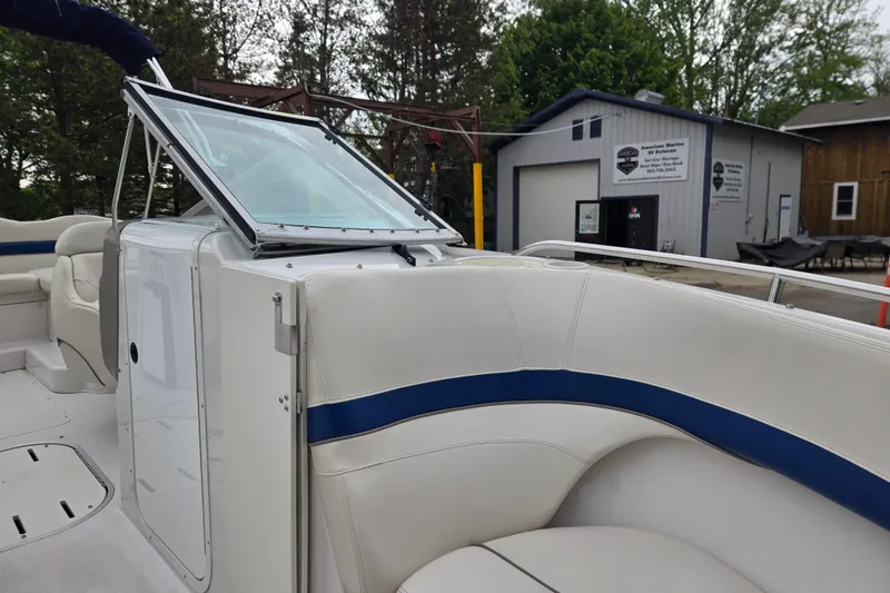 Slide: The Image of 2001 Four Winns 230 Horizon boat interior with white seating and windshield. - 32