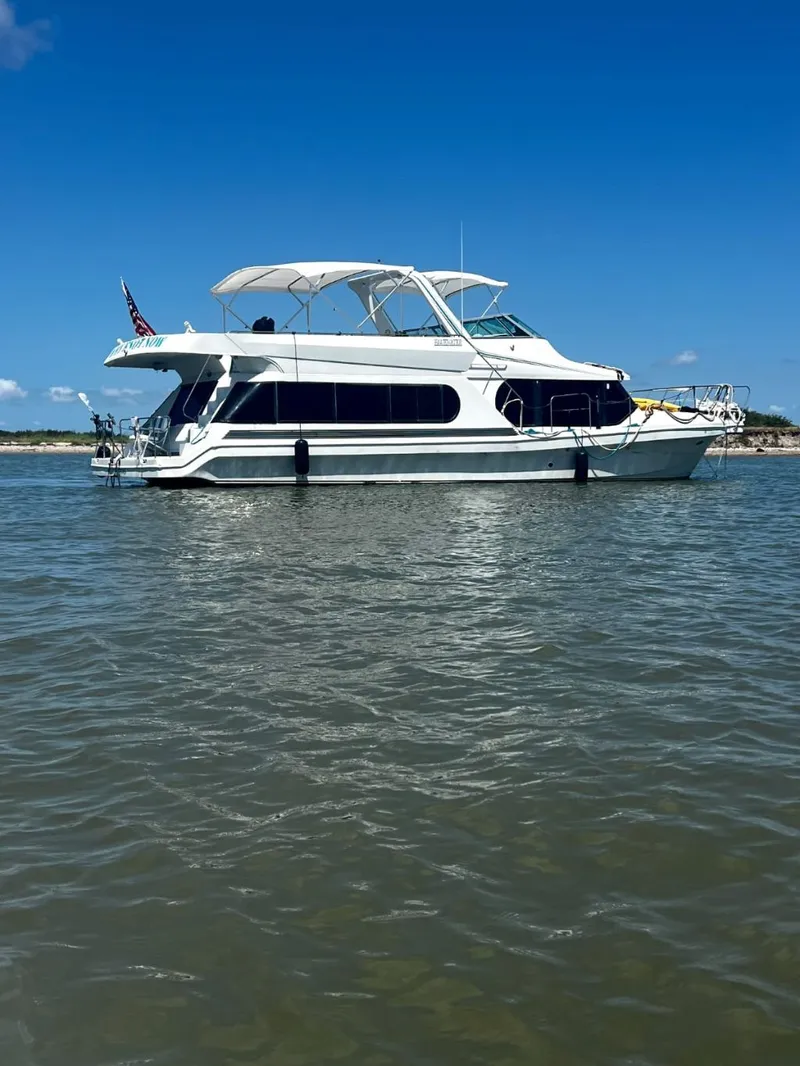 The Image of 1997 Bluewater Yachts 510 on calm water under clear sky. - 0