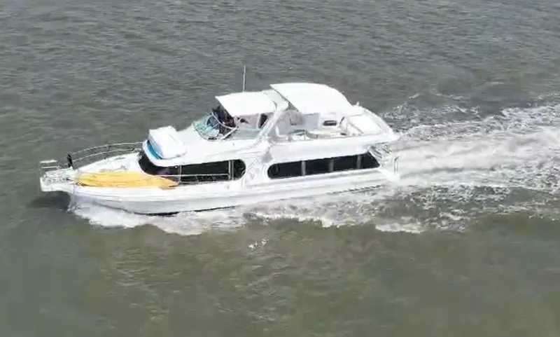 Slide: The Image of 1997 Bluewater Yachts 510 cruising on the water. - 1